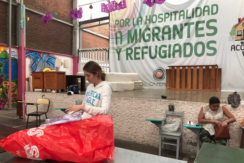 Isabella Mariel, a volunteer, teaches migrants basic skills like cooking food, making bread,...