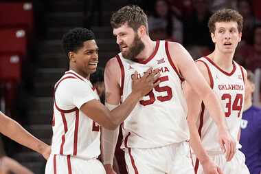 Oklahoma guard Grant Sherfield, left, celebrates with forward Tanner Groves (35) in the...
