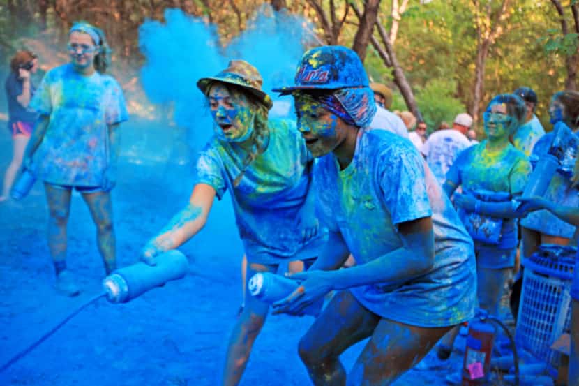 Parker Holt (left) and Rose Njoku, both 15, squirted walkers with colored powder during the...