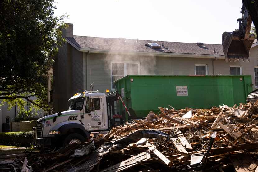 A dust cloud rises as a crew clears the demolished home at 4415 Fairfax in Highland Park on...
