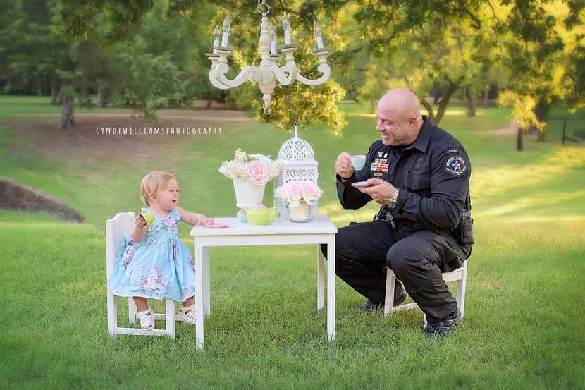 Tarrant County Deputy Constable Mark Diebold shares some tea with Evelyn Hall, whom he...