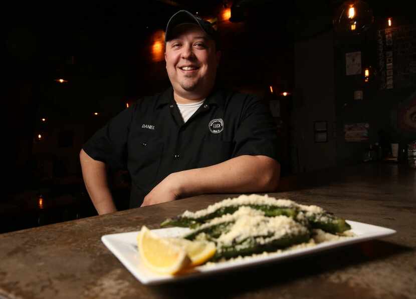 Chef Daniel Pittman poses for a photo with his charred okra at LUCK in Dallas on Aug. 31,...