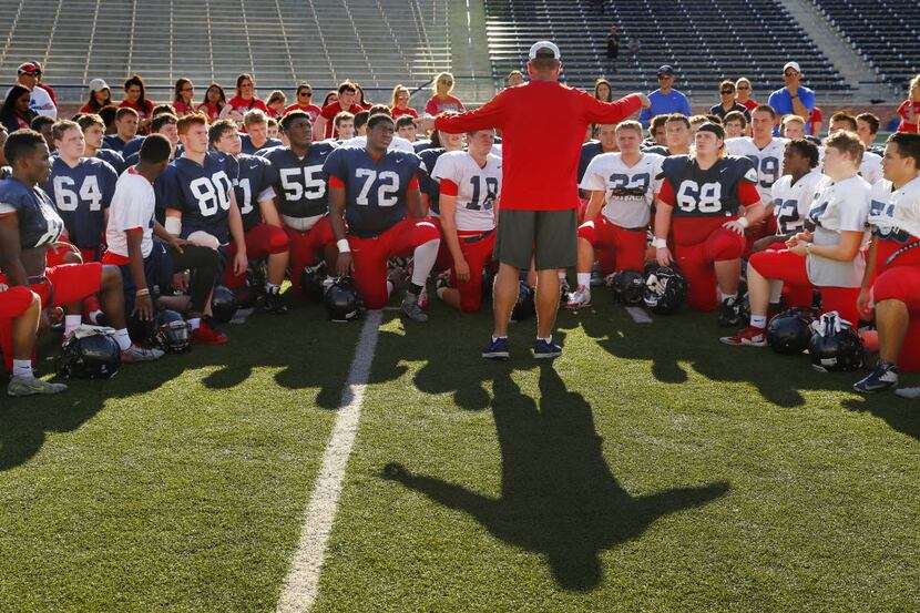New Allen head football coach Terry Gambill (center) gathers his players for a post spring...