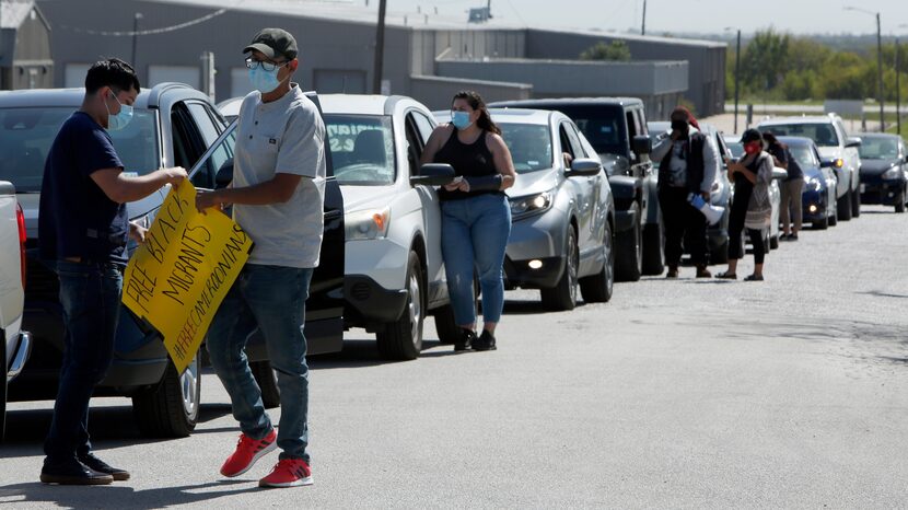 A group gathered for a socially distanced car caravan protest outside the Prairieland...