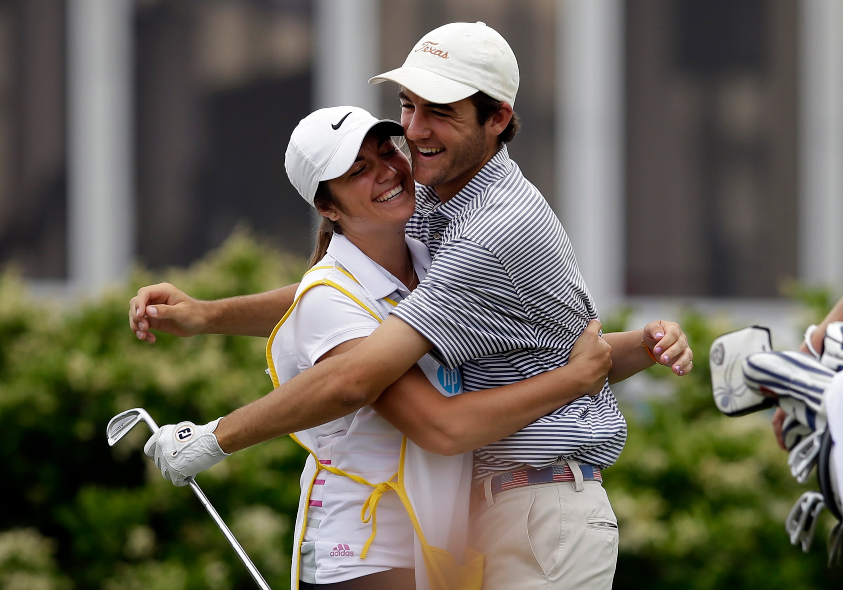 Scottie Scheffler, 17, of Highland Park High School in Dallas, is hugged by his sister...