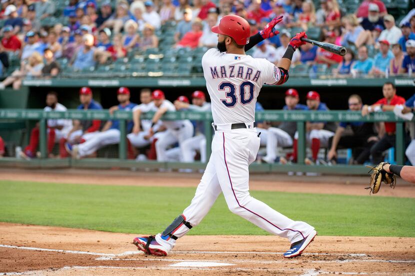 Texas Rangers' Nomar Mazara follows through on a two-run home run off Chicago White Sox...