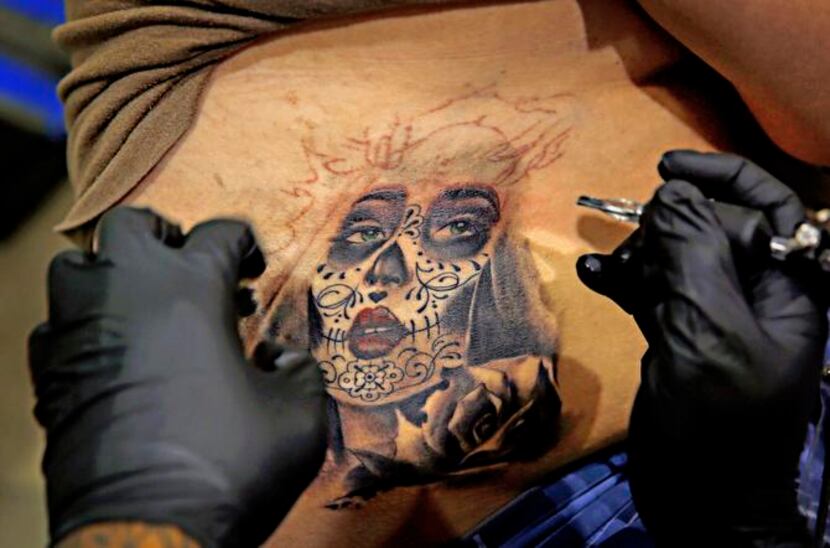 
Chicago-based artist Angel Silva tattooed Daniel Martinez of Granbury at the festival...