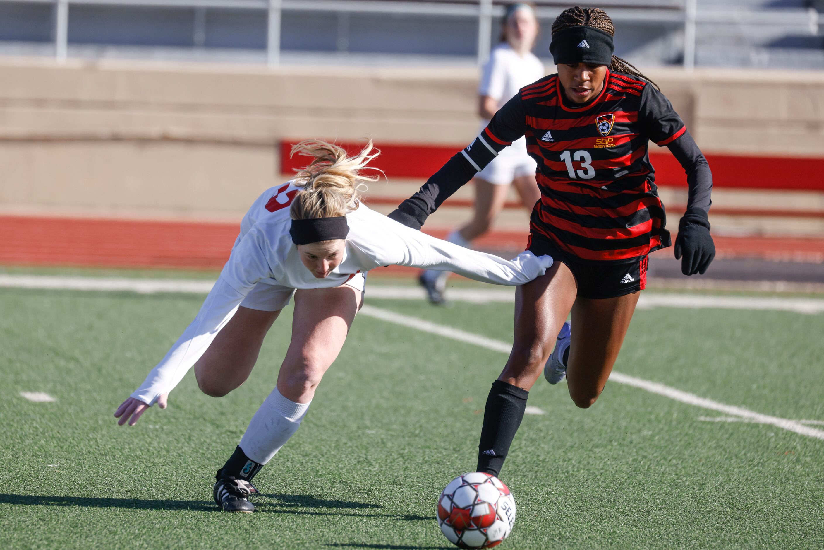 Grapevine High School Sydney Martin, left, loses her drip on the ball against South Grand...