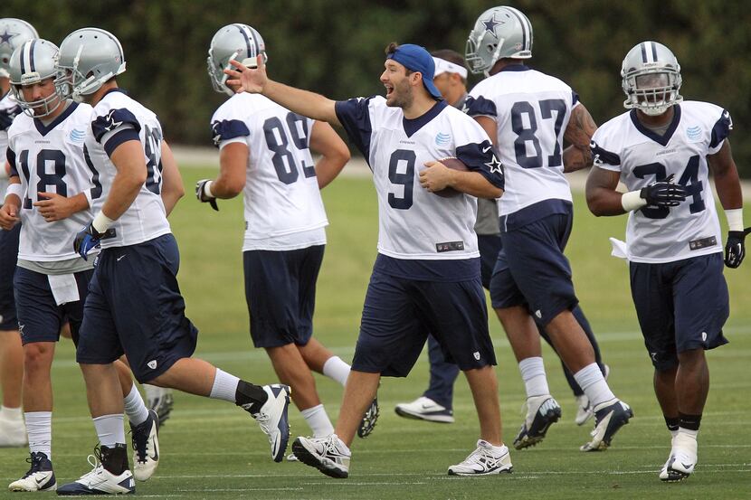 Dallas quarterback Tony Romo (9) directs teammates during the Dallas Cowboys first OTA...