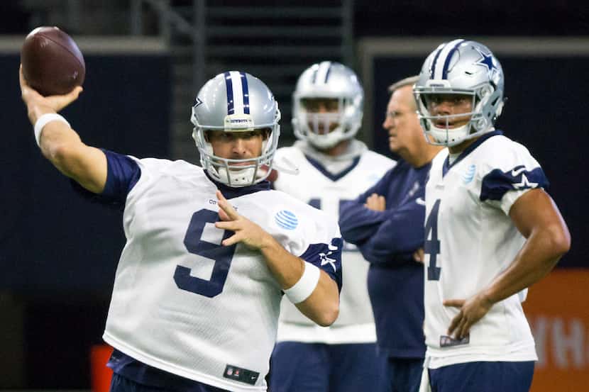 Dallas Cowboys quarterback Tony Romo (9) throws a pass as quarterback Dak Prescott (4) looks...