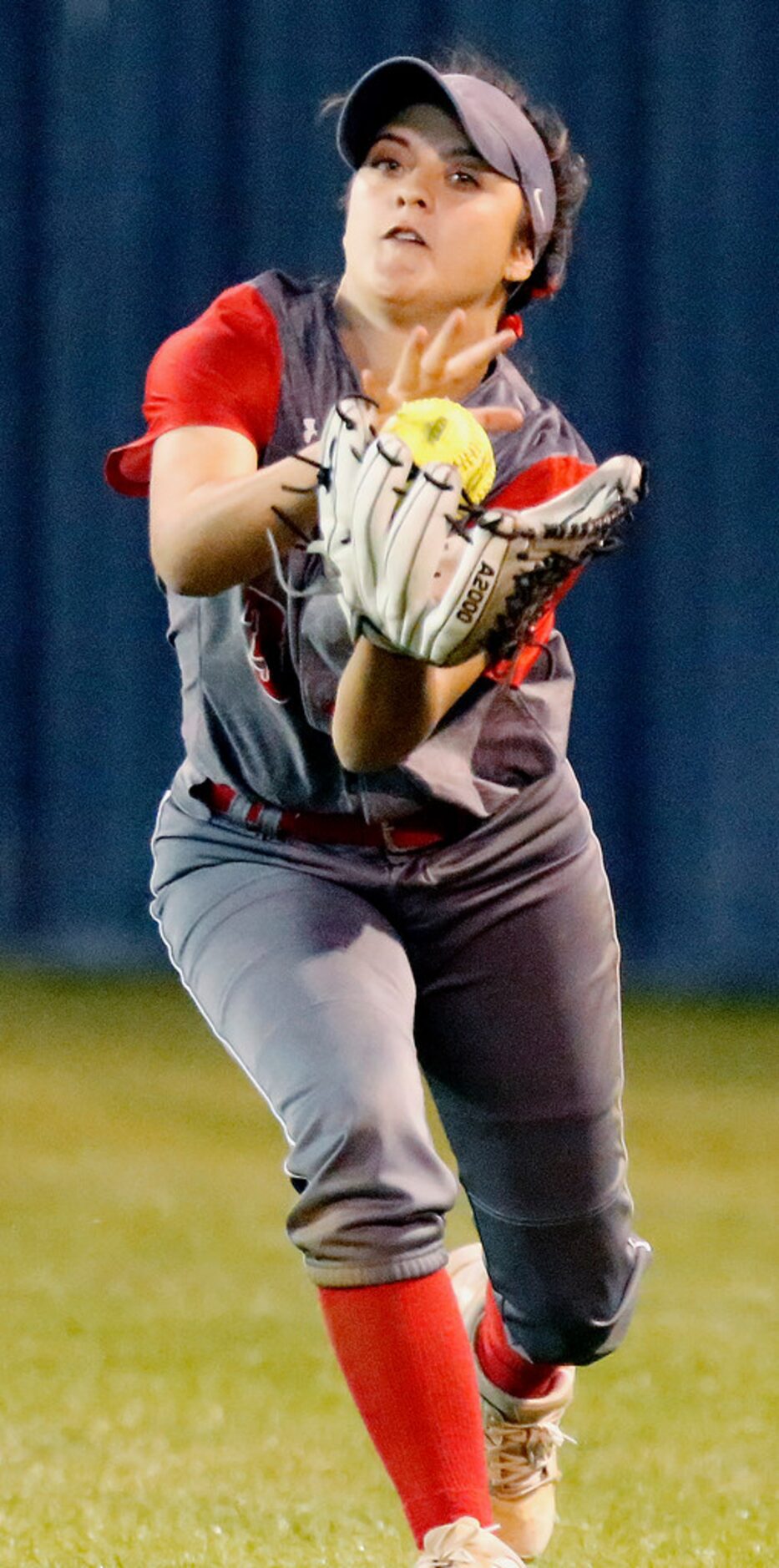 McKinney Boyd High School center fielder Katy Loera (3) makes a running catch in the third...