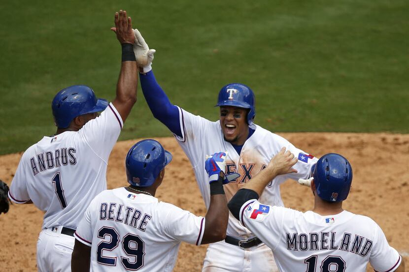 Texas Rangers left fielder Carlos Gomez (upper right) is congratulated on his fourth inning...