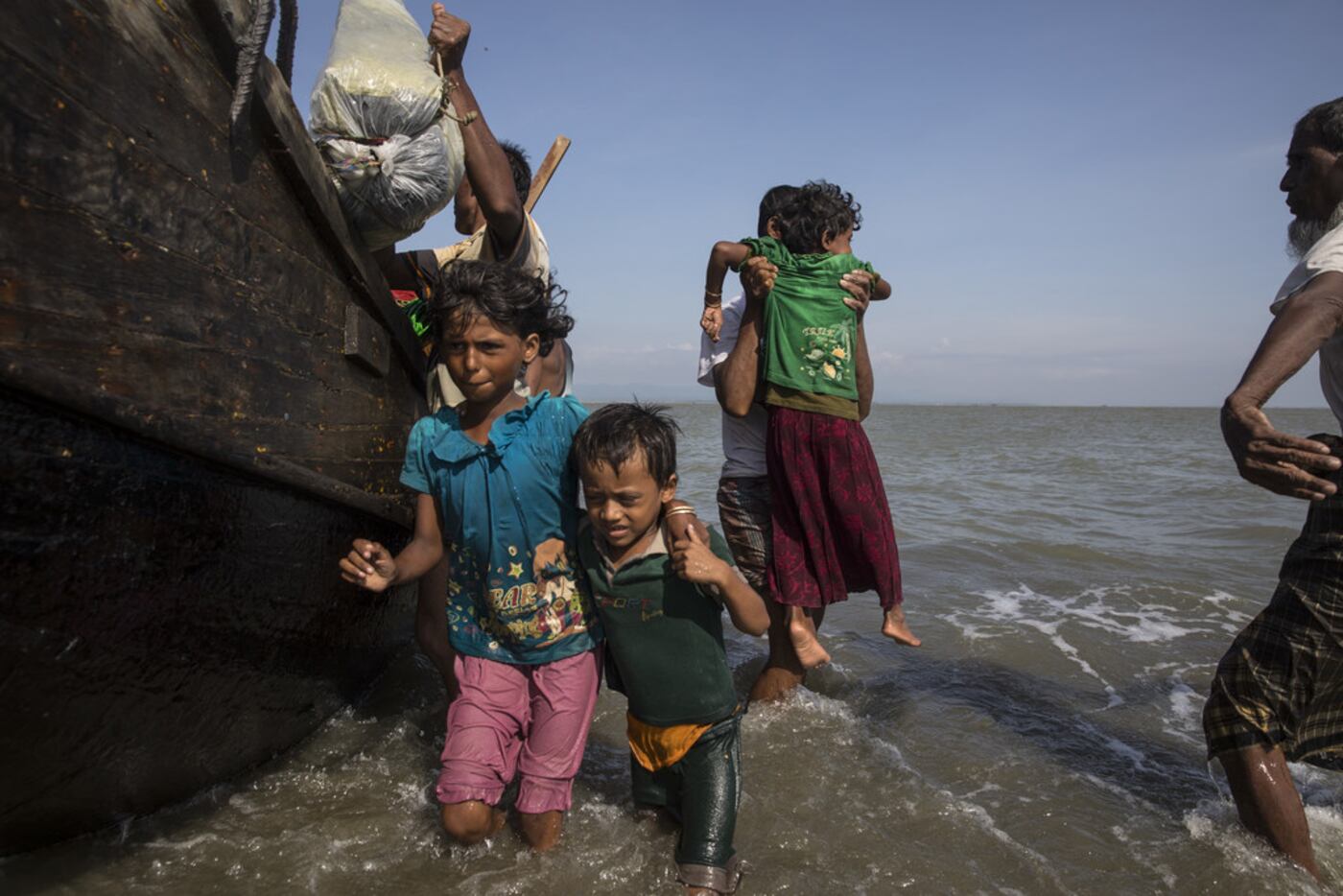 Desperate Rohingya Muslims continued Saturday to arrive by boat from Myanmar as land...