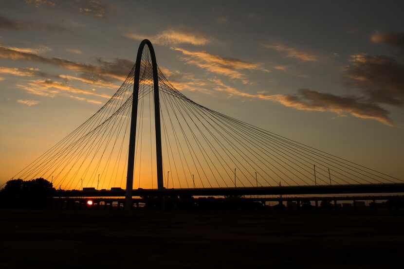The sun sets behind the Margaret Hunt Hill Bridge in Dallas.