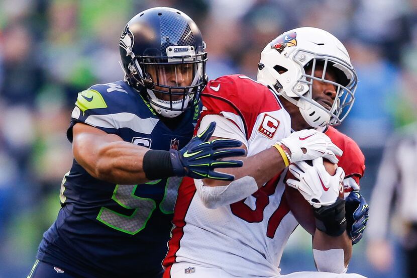 SEATTLE, WA - DECEMBER 30: Bobby Wagner #54 of the Seattle Seahawks tackles David Johnson...