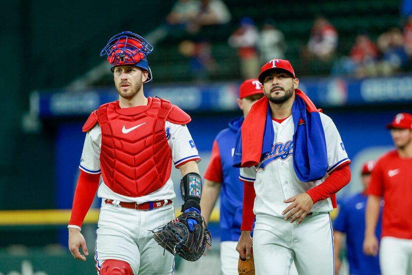 Texas Rangers catcher Mitch Garver (18) and Texas Rangers starting pitcher Martin Perez (54)...