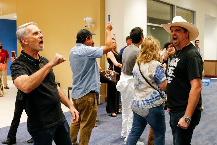 Opponents of mask mandates chant to be let in during a Dallas ISD school board meeting...