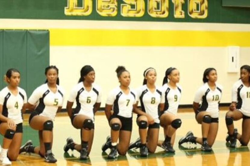 Members of the DeSoto High School volleyball team knelt in protest before a game Wednesday.