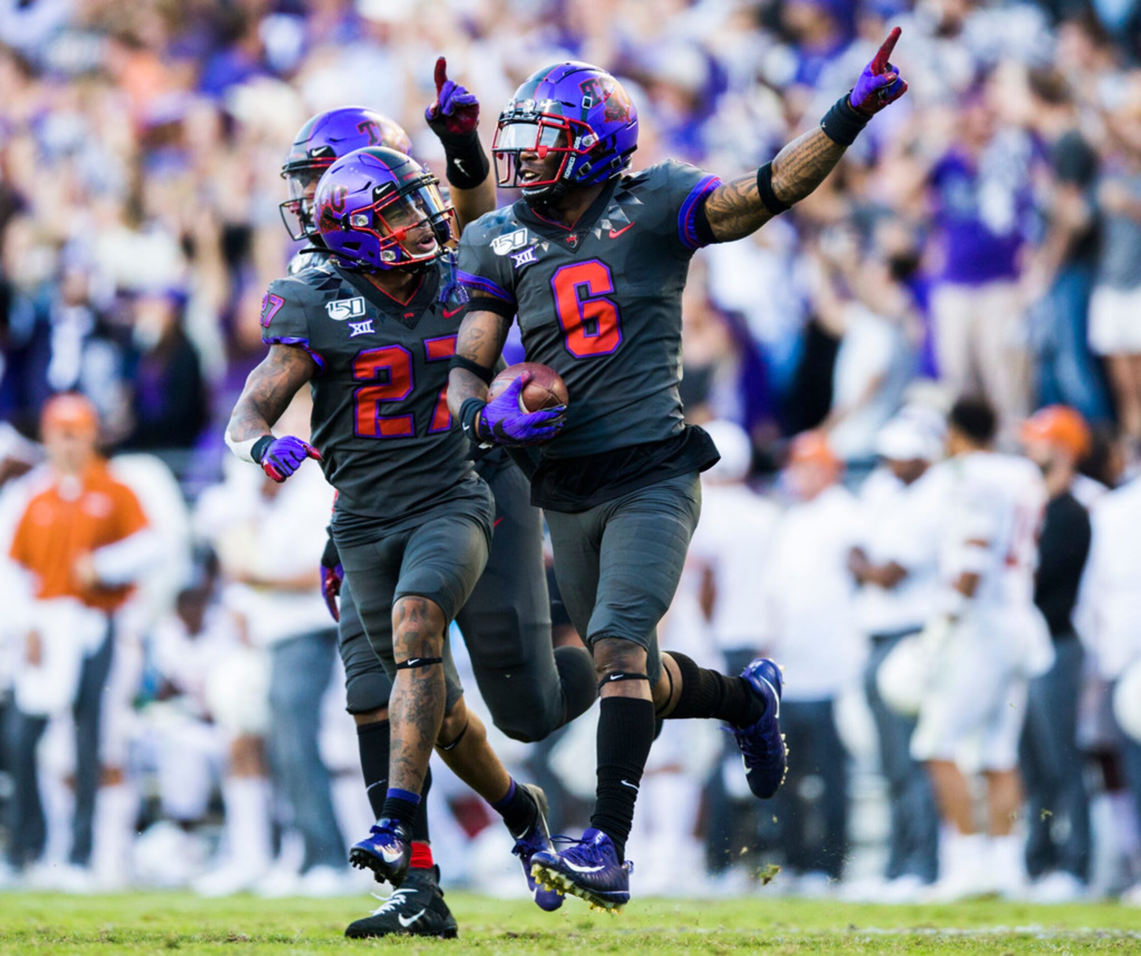 TCU Horned Frogs safety Ar'Darius Washington (27) and safety Innis Gaines (6) celebrate...