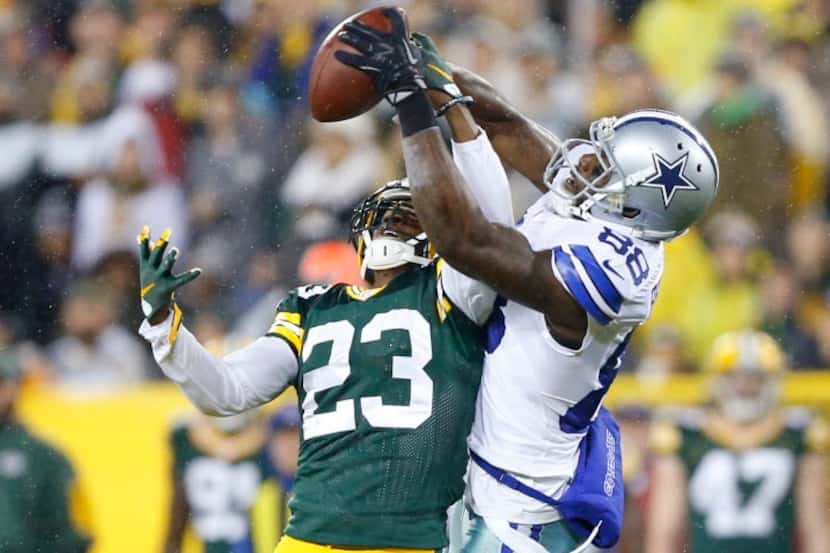 Dallas Cowboys wide receiver Dez Bryant (88) somehow manages to pull the ball down despite...