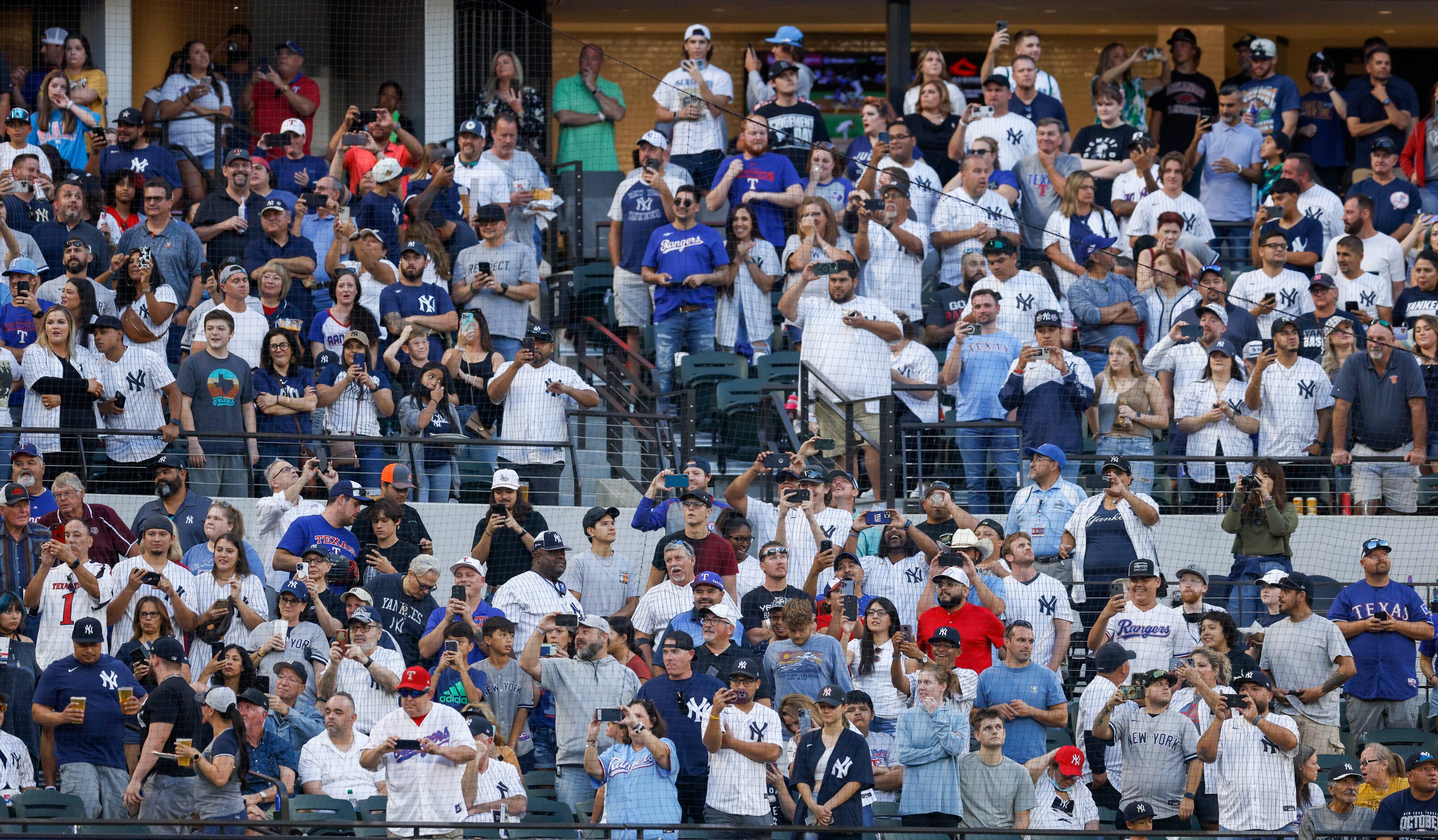 Fans stand up and watch as New York Yankees right fielder Aaron Judge takes an at bat during...