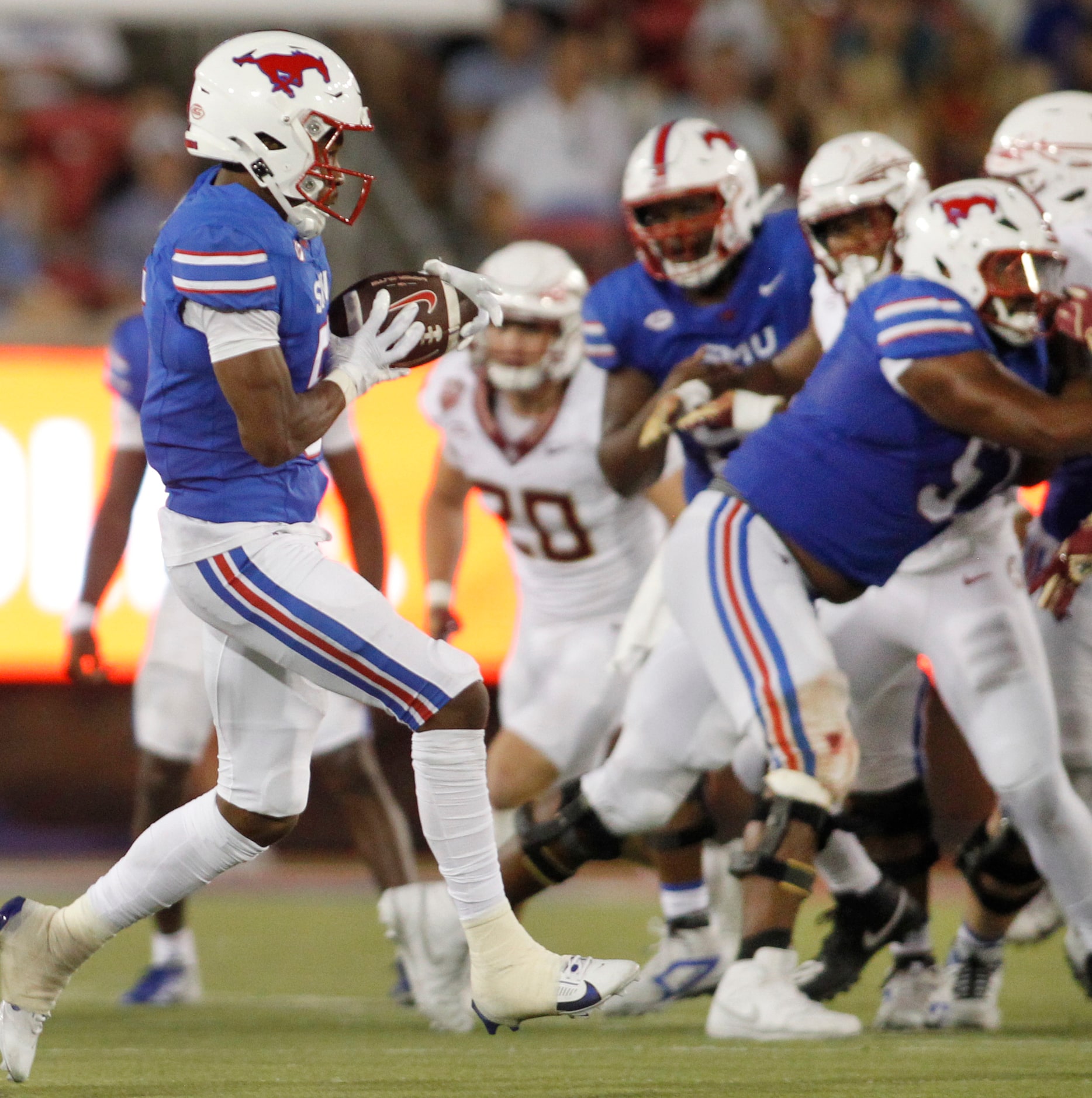 SMU Mustangs receiver Moochie Dixon (5), left, pulls in a pass across the middle during...