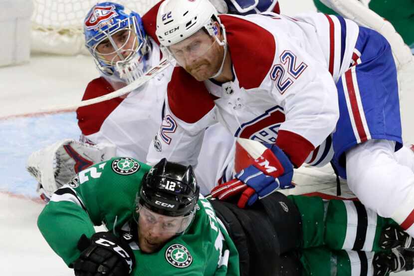 Dallas Stars center Radek Faksa (12) reaches for the puck against Montreal Canadiens...