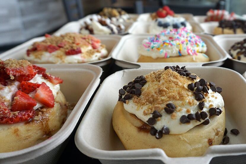 A row of cinnamon rolls await hungry customers at a Cinnaholic location. The company plans...