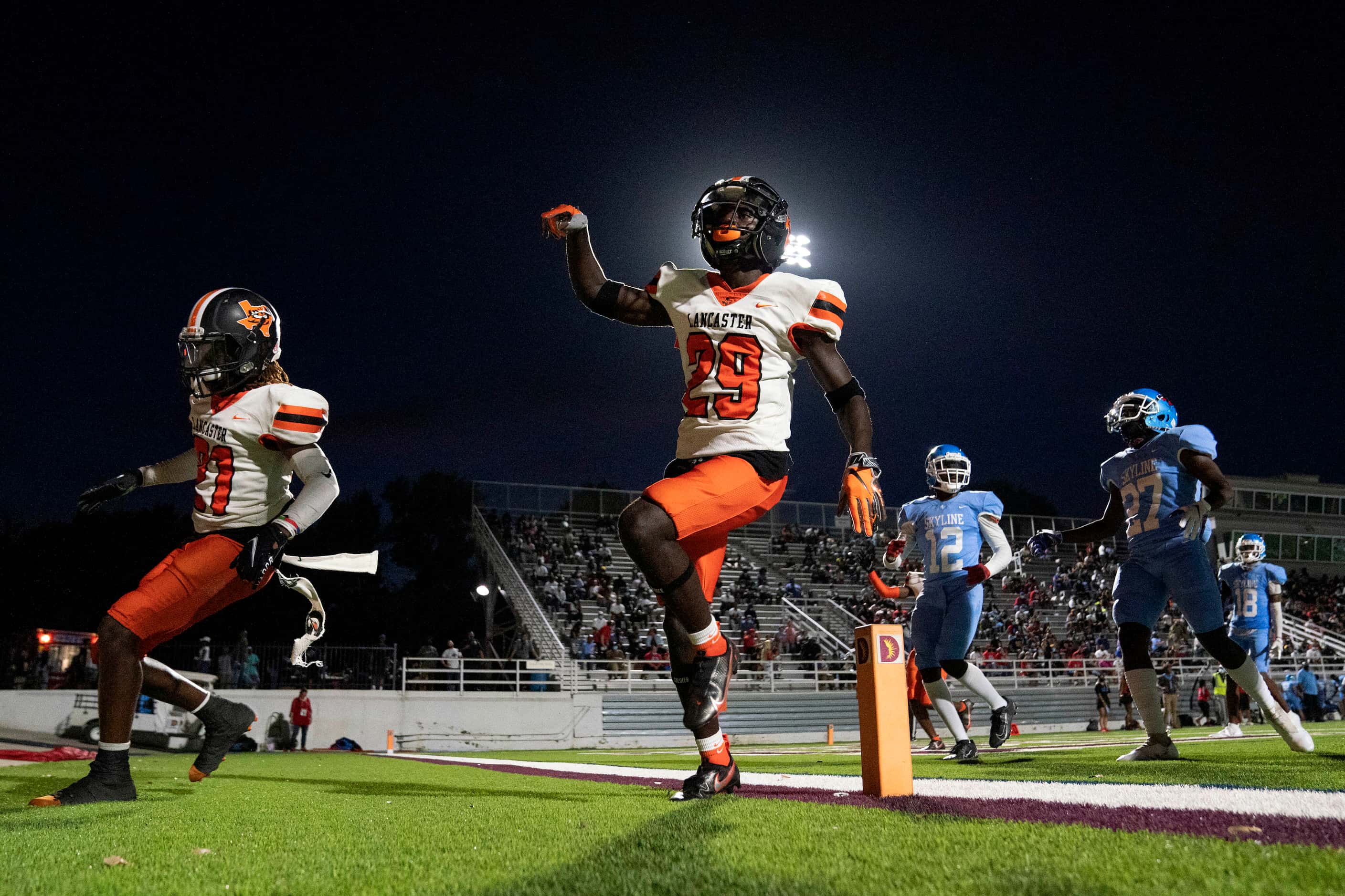 Lancaster defenders celebrate a safety after Skyline snapped the ball out of the back of the...