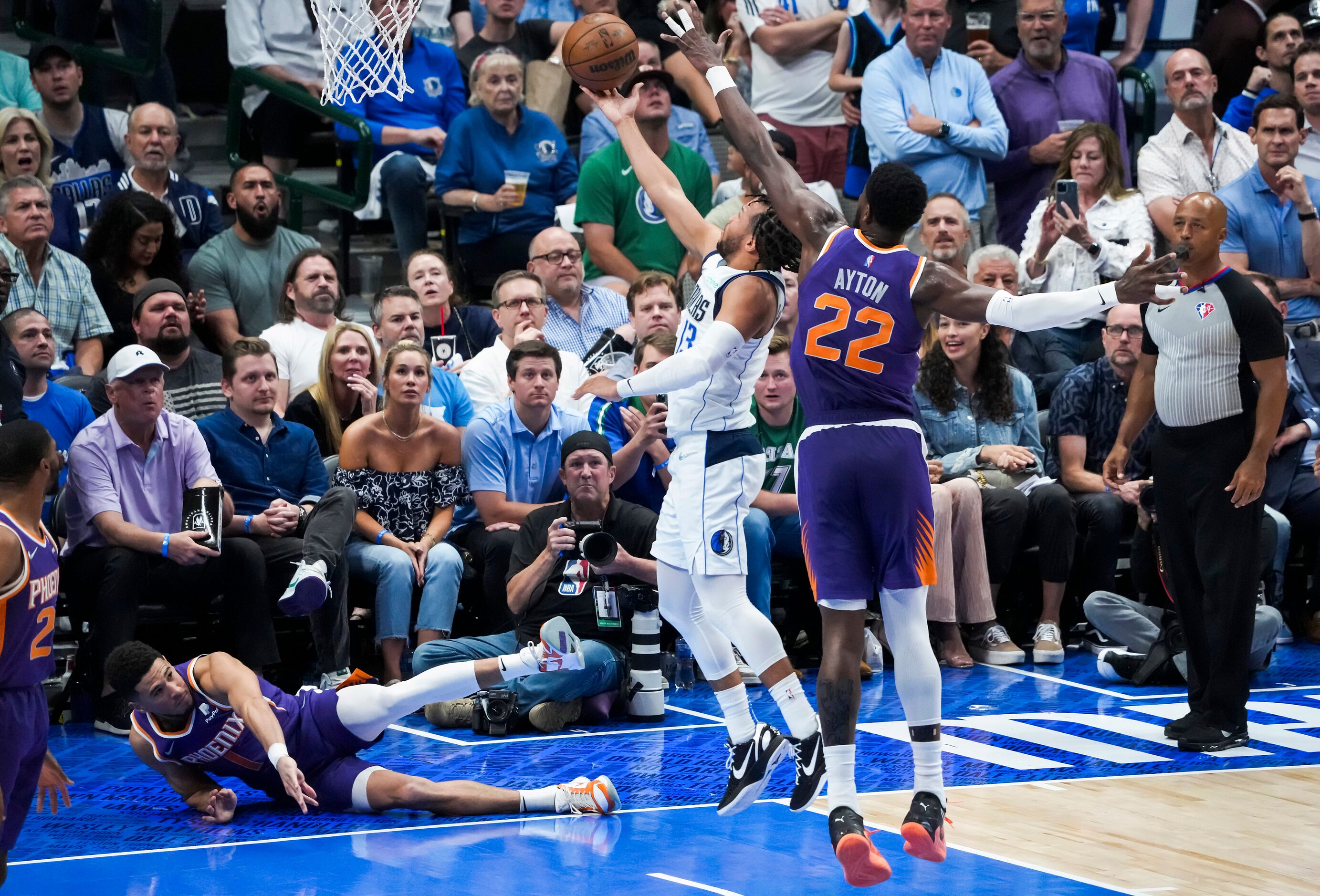 Dallas Mavericks guard Jalen Brunson (13) scores past Phoenix Suns center Deandre Ayton (22)...