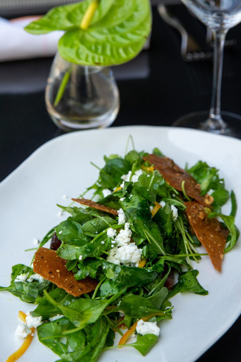 Arugula salad with preserved Meyer lemon, marinated dates and pistachio tuile 