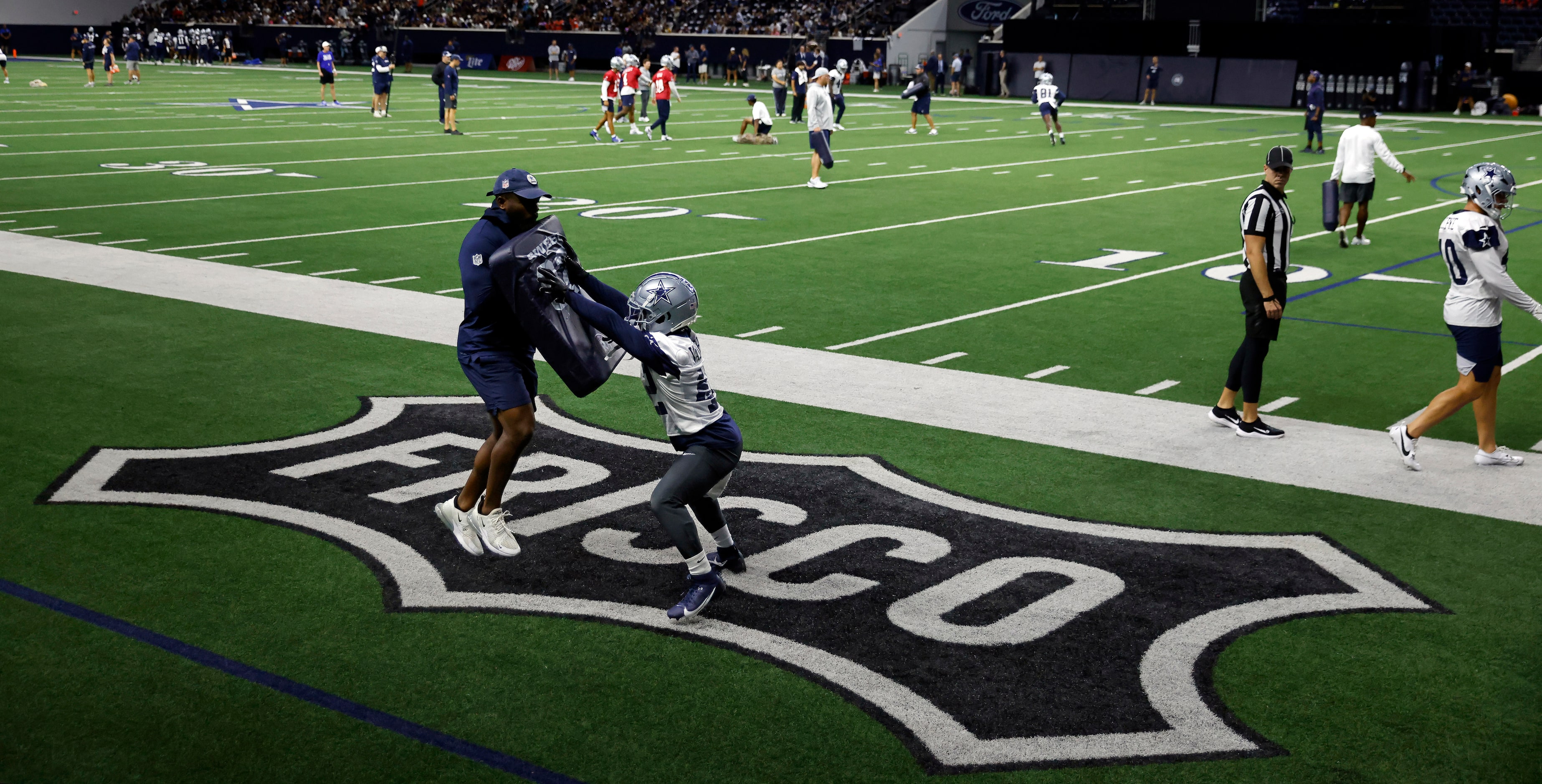 Dallas Cowboys running back Deuce Vaughn (42) gets leverage on a hitting drill during the...