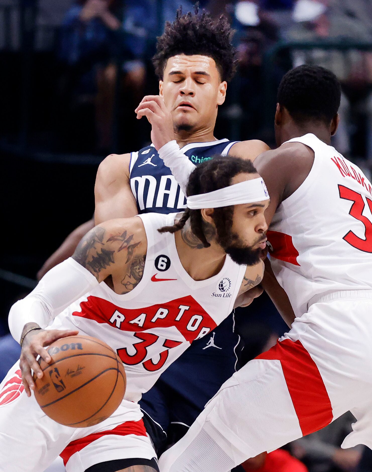 Dallas Mavericks guard Josh Green (8) runs into Toronto Raptors forward Christian Koloko...