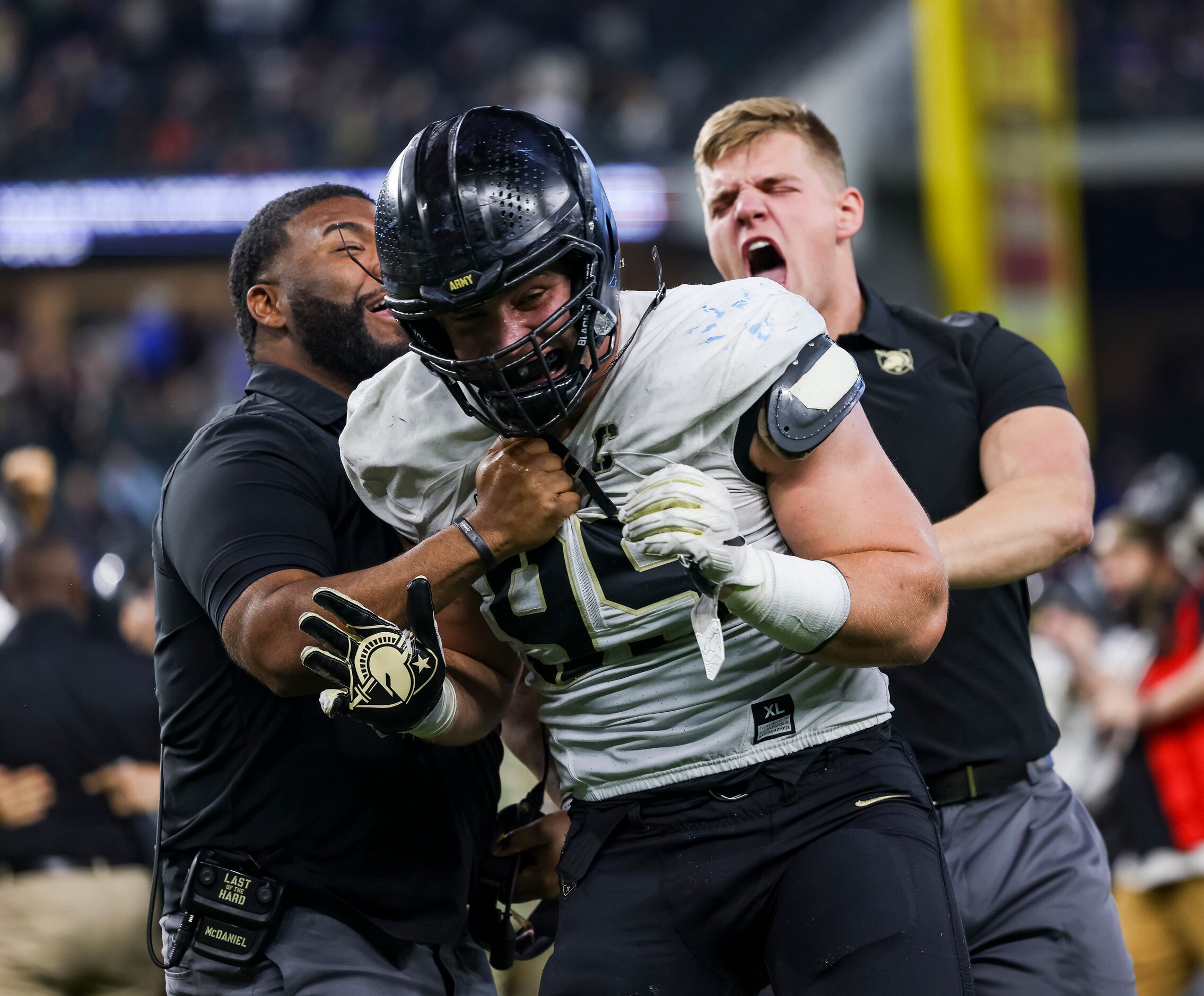 Army Black Knights defensive lineman Nolan Cockrill (95) and coaches celebrate winning...