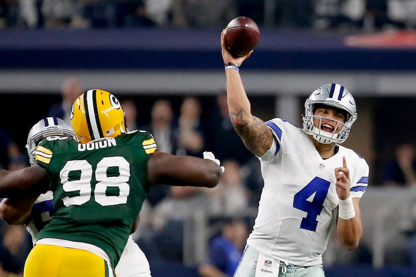 Dallas Cowboys quarterback Dak Prescott (4) throws the ball downfield over Green Bay Packers...