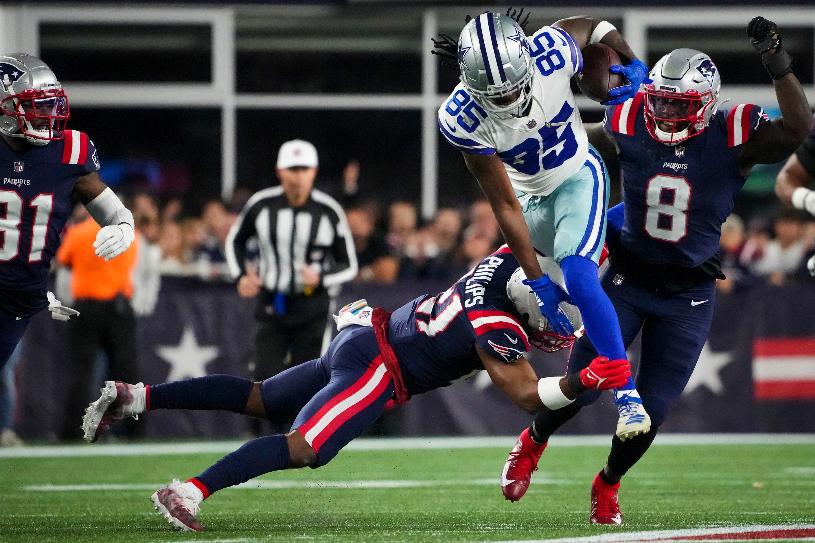 Dallas Cowboys wide receiver Noah Brown (85) is brought down by New England Patriots safety...