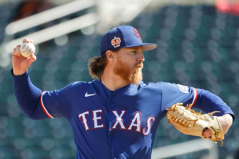 Texas Rangers pitcher Jon Gray delivers during the first inning of a spring training game...