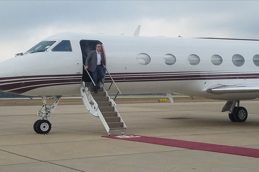 New A&M coach Jimbo Fisher exits a plane at Easterwood Airport in College Station on Sunday...