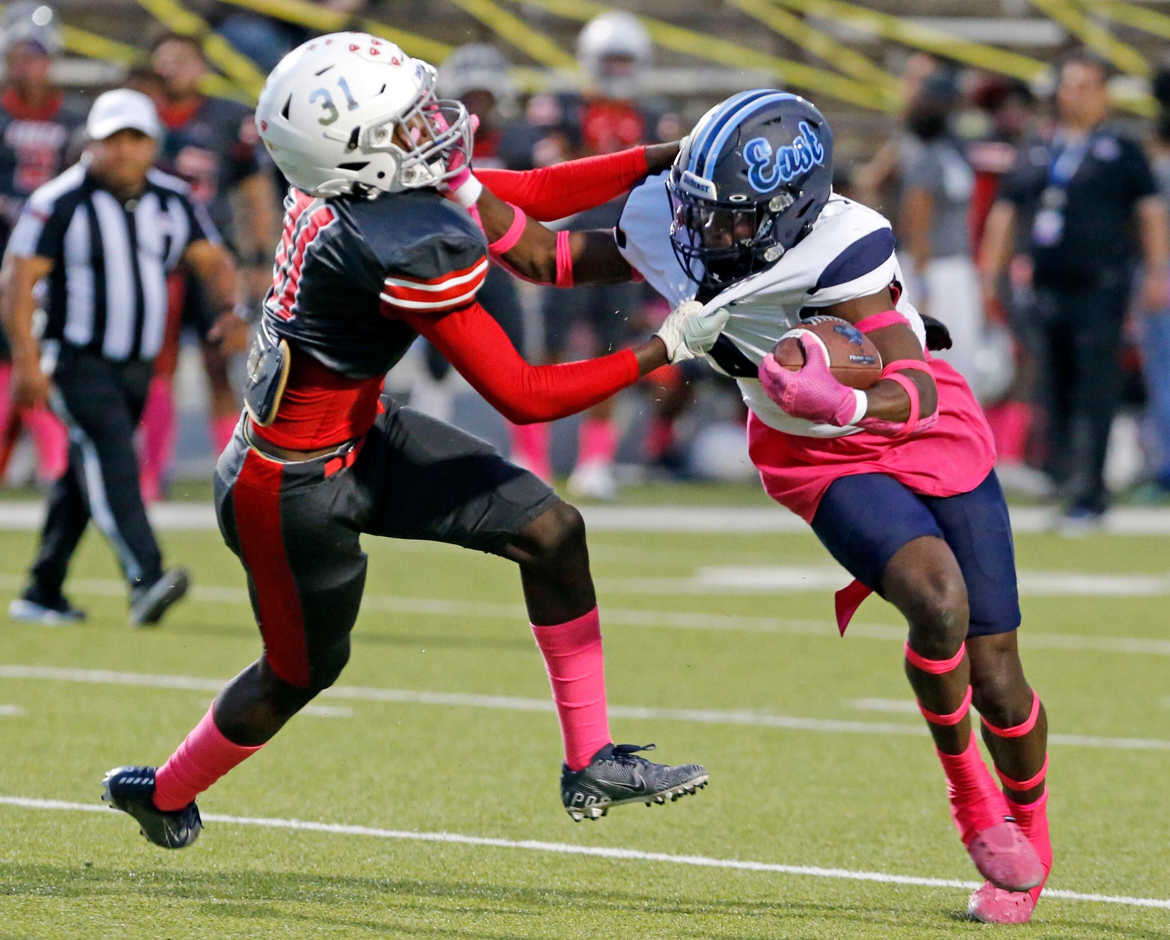 Wylie East high’s Tristan Lee (4) battles for yardage, as South Garland high’s Antonio...