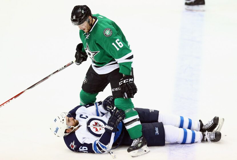 DALLAS, TX - JANUARY 15: Ryan Garbutt #16 of the Dallas Stars skates over Andrew Ladd #16 of...