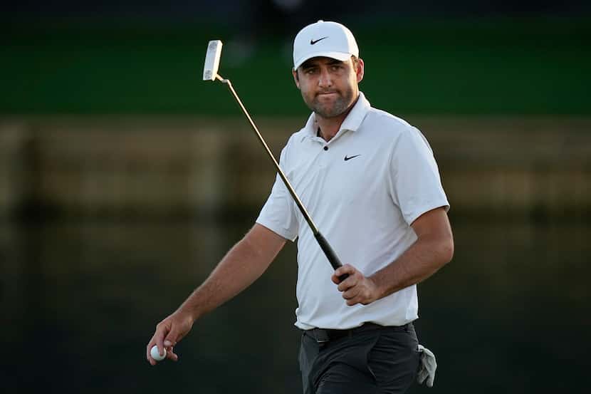 Scottie Scheffler walks on the 18th green during the third round of the Players Championship...