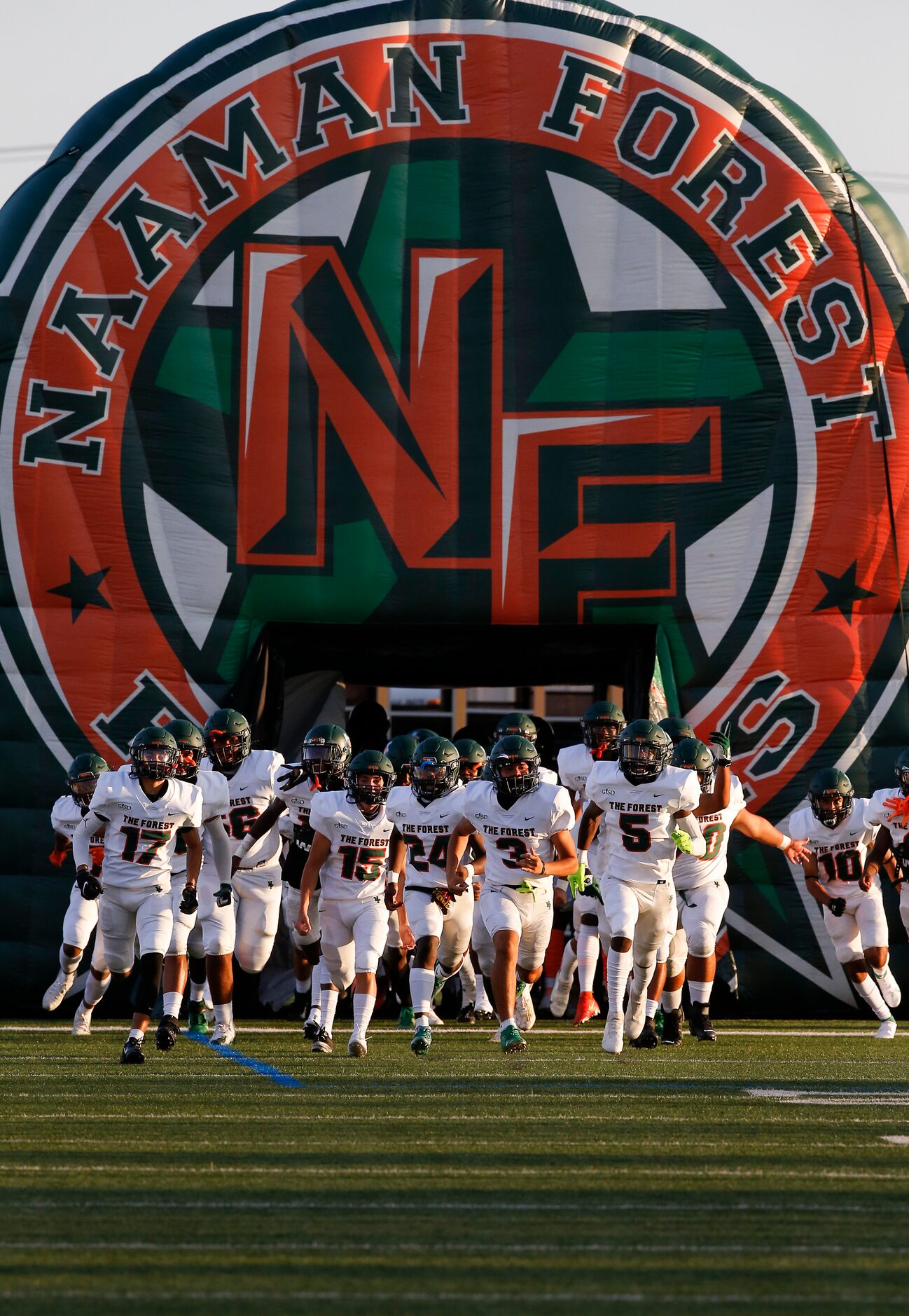 Garland Naaman Forest runs onto the field for the start of a high school football game...