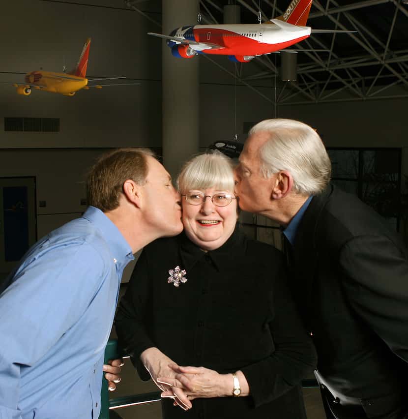 Gary Kelly (left) and Herb Kelleher chairman give Colleen Barrett a kiss on the cheek in the...