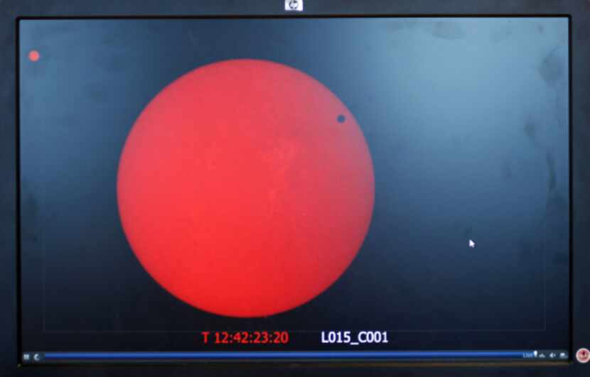 A live feed of the transit of Venus is shown on a computer screen at the University of Texas...