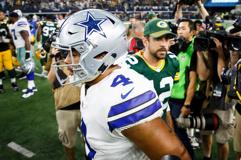 Dallas Cowboys quarterback Dak Prescott (4) greets Green Bay Packers quarterback Aaron...