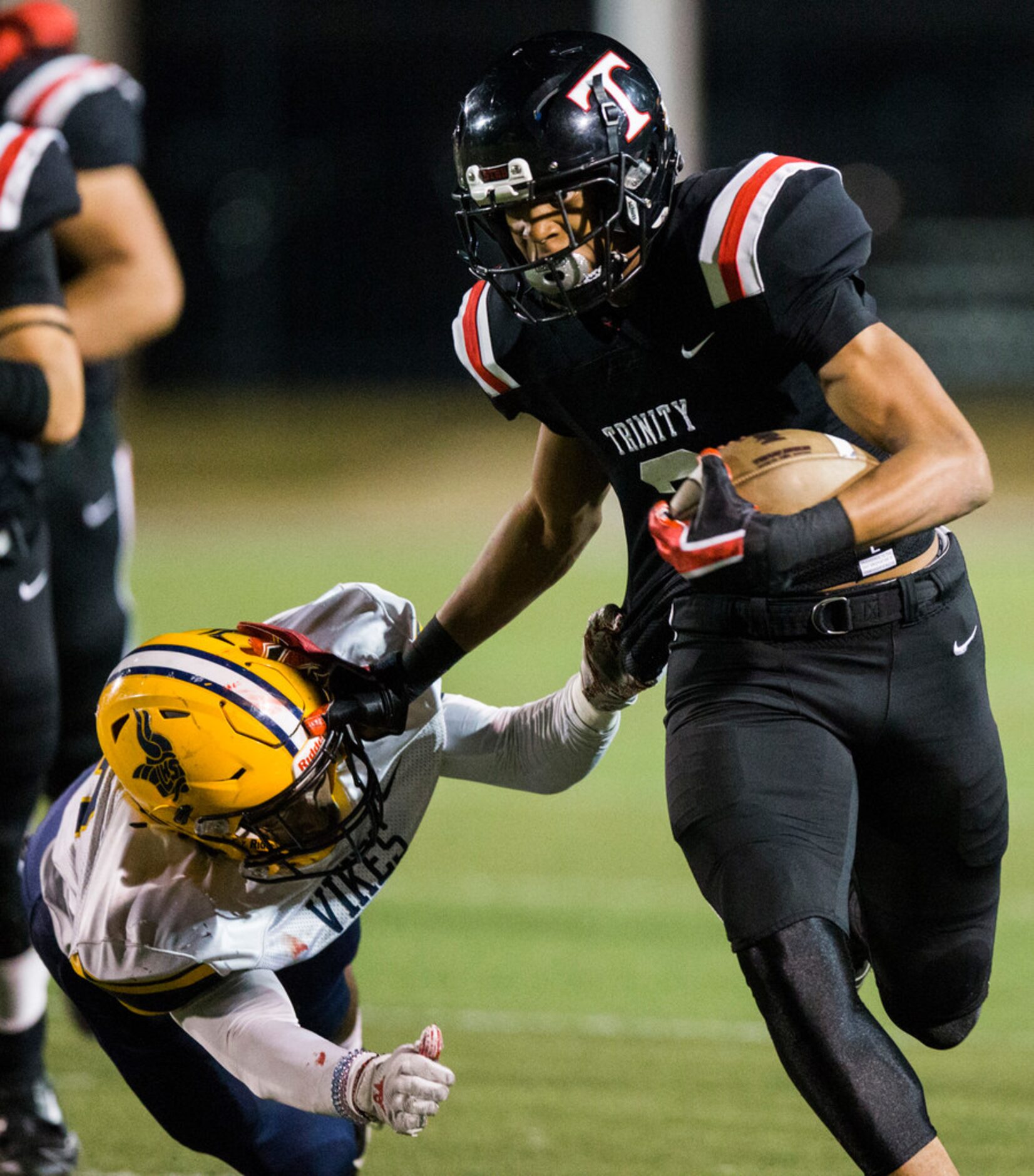 Euless Trinity running back Ollie Gordon (2) pushes away Arlington Lamar offensive...