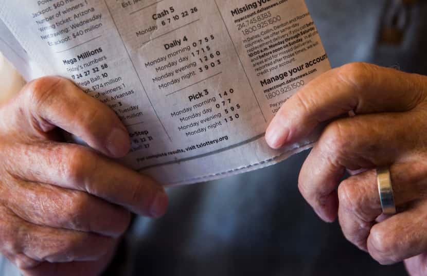 Norman Kantor, 90, holds the Texas lottery numbers published in an issue of The Dallas...