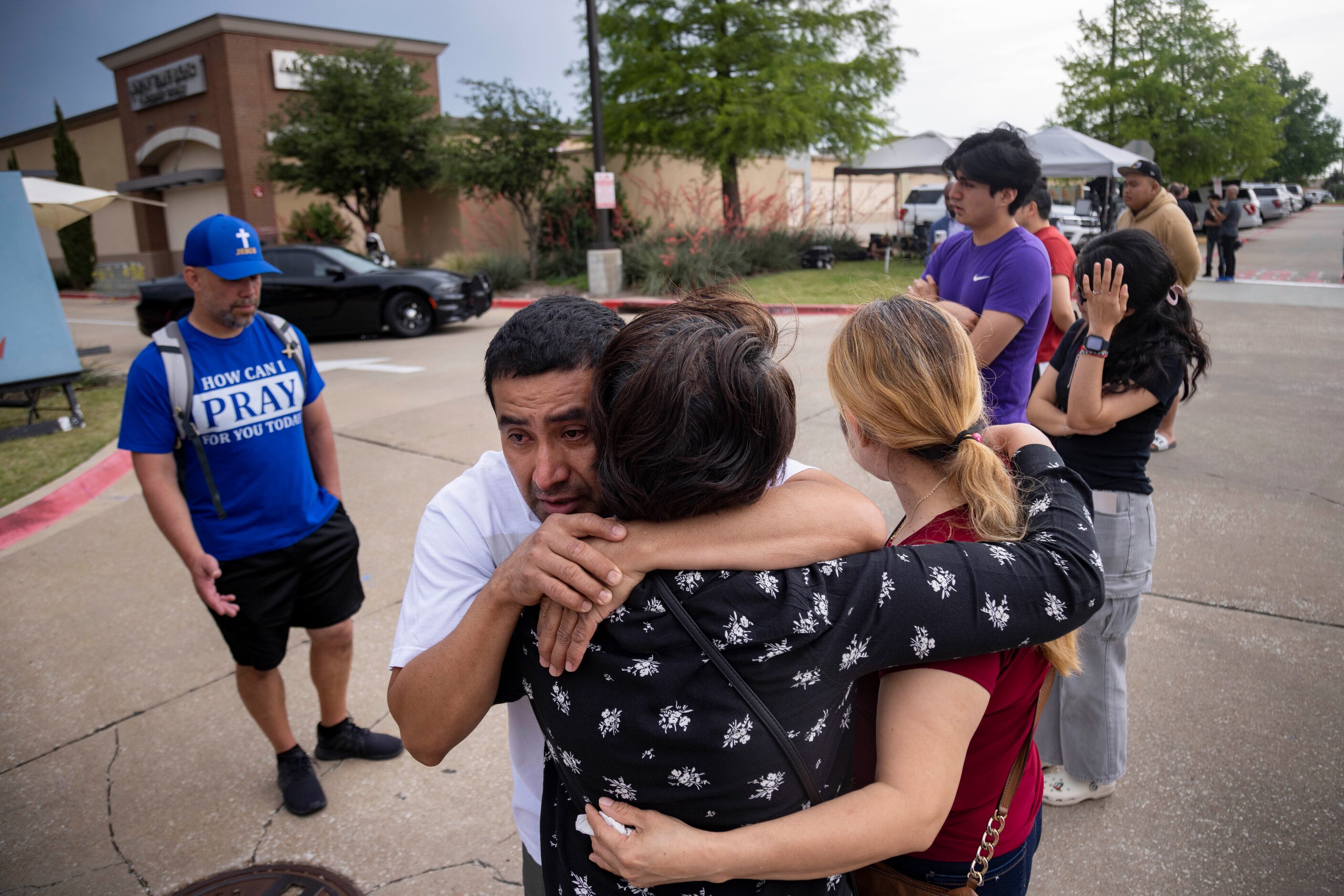 Gina Bennet (center) embraces Victor Ramirez and his wife Humbertina Ramirez as they reunite...