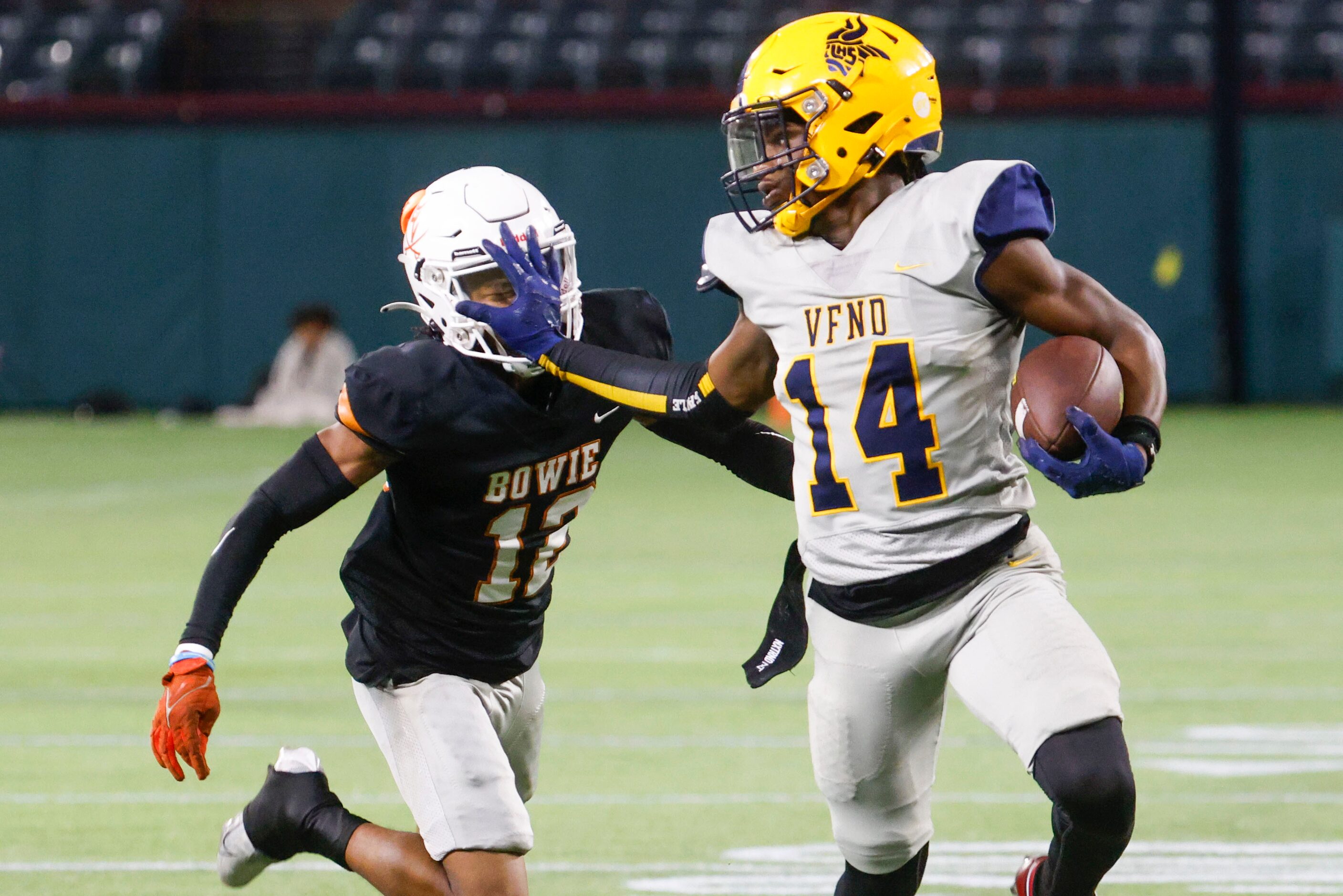 James Bowie High’s Jordan Patterson (left) gets blocked by Lamar High’s Trenton Yancey (14)...