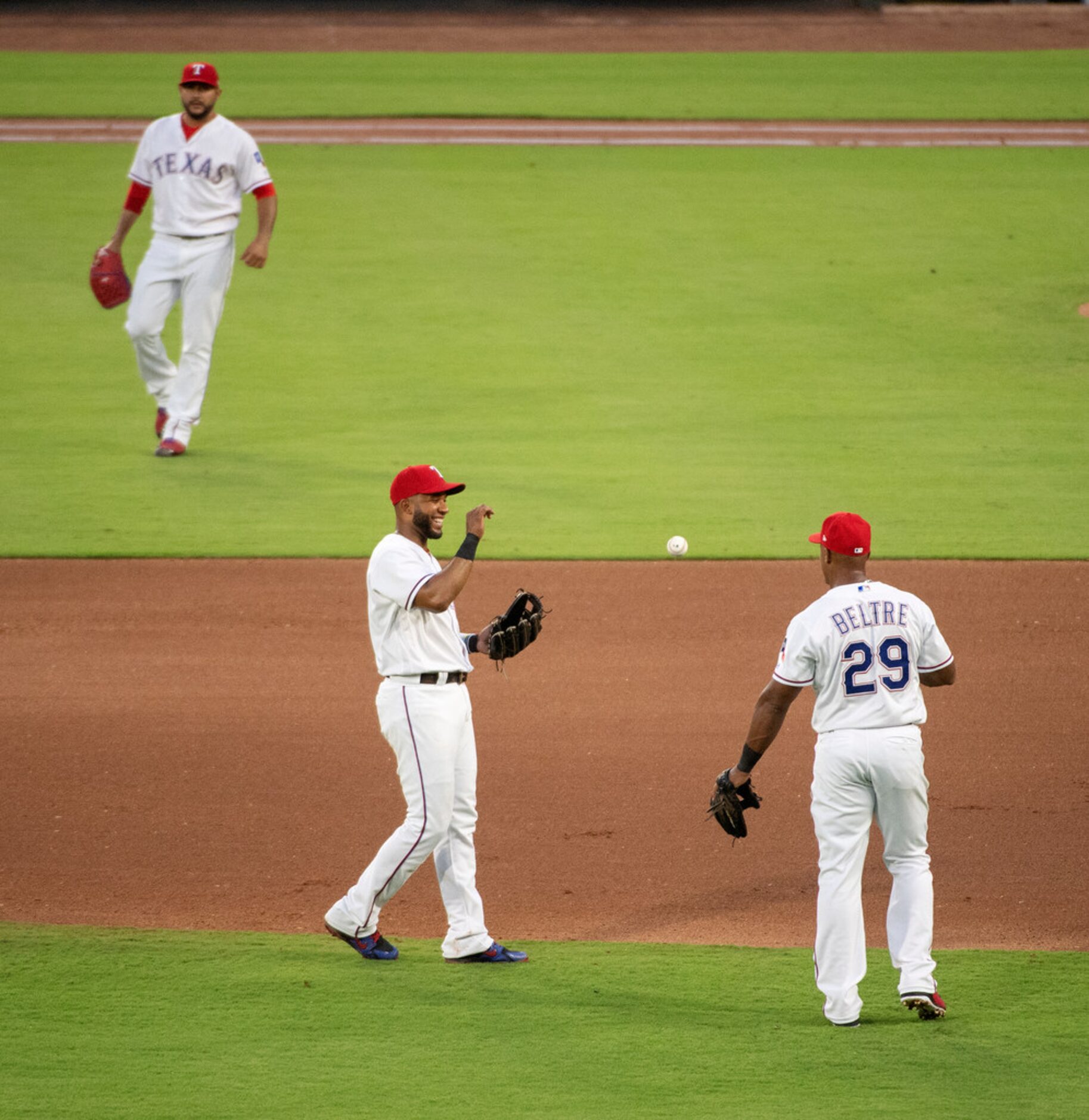 Texas Rangers third baseman Adrian Beltre (29) flips the ball to shortstop Elvis Andrus...